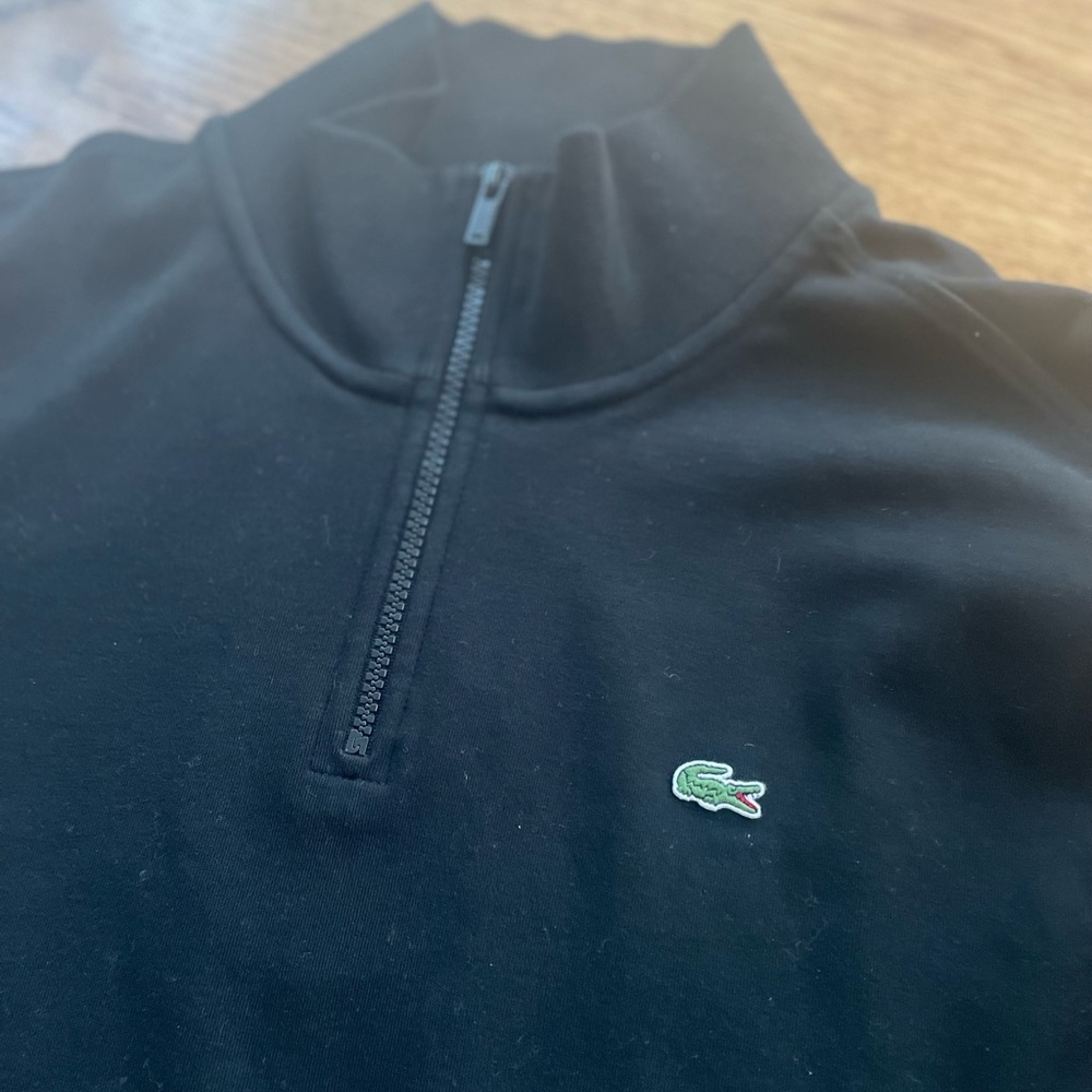 Black PreOwned men’s Lacoste large quarter zip pullover.